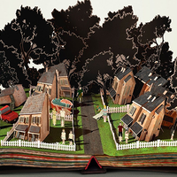 Otwarta książka z której wystają jak pop-up domy i drzewa